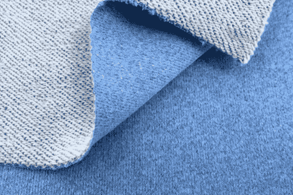 Close-up of blue fabric with a textured white inner layer.