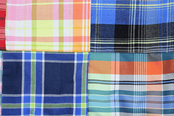 Four plaid fabrics in pink, yellow, blue, and orange patterns.