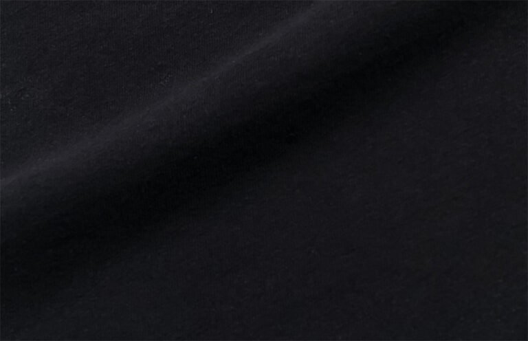 Black cotton-polyester blend fabric texture close-up.