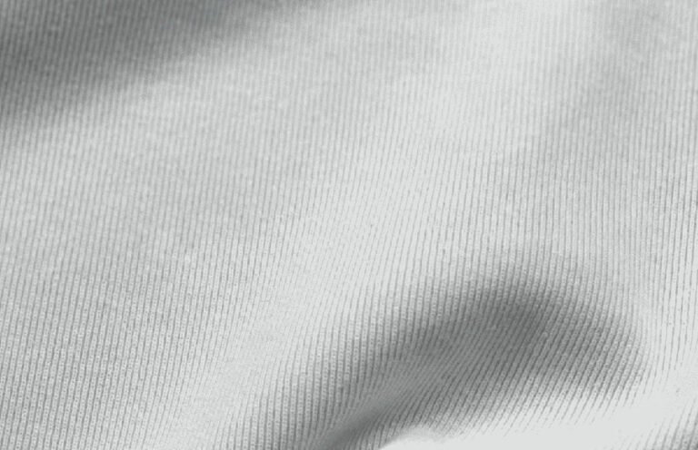 Light grey ribbed knit fabric with soft surface texture.