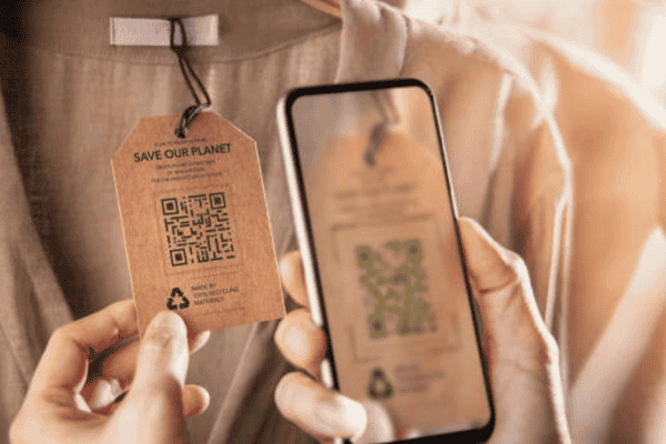 Smartphone scanning a QR code on clothing tag for DPP data